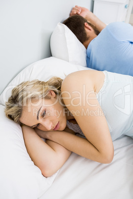 Woman upset with the man after a fight on bed