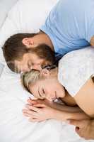 Couple sleeping on bed