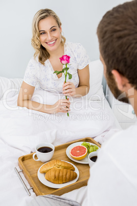 Couple having breakfast in bed