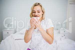 Woman having coffee in bed