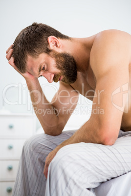 Depressed man with hand on head