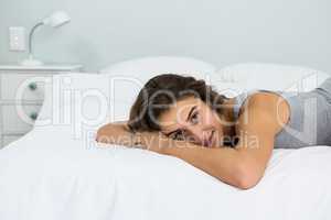 Portrait of beautiful woman lying on bed