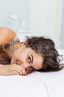 Portrait of beautiful woman lying on bed