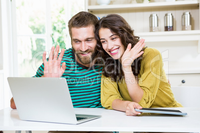 Couple having video chat on laptop
