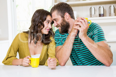 Couple having coffee in kitchen