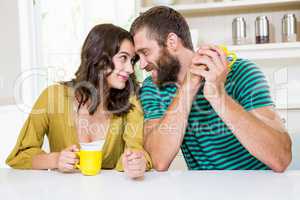 Couple having coffee in kitchen