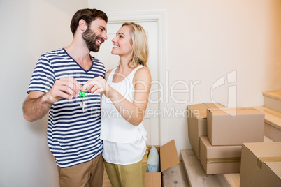 Couple holding keys in their new house