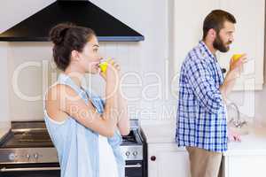 Young couple having cup of coffee in kitchen