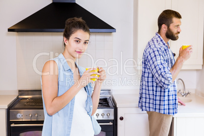 Young couple having cup of coffee in kitchen