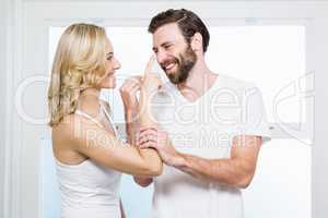 Woman applying cream to her man