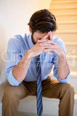 Worried man sitting on stairs