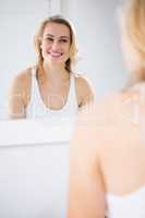 Young woman looking into a mirror