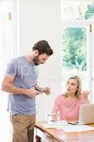 Worried young couple discussing on bills