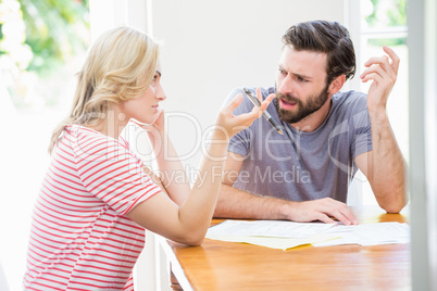 Worried young couple discussing on bills