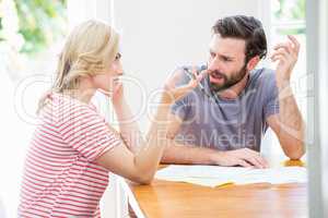 Worried young couple discussing on bills