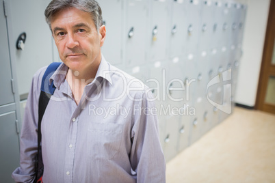 Portrait of professor standing in locker room