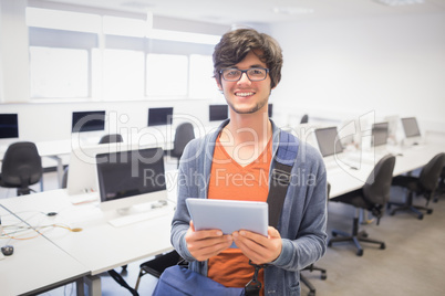 Portrait of happy student holding digital tablet