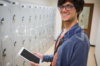 Portrait of student using digital tablet in locker room