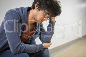 Thoughtful student sitting on chair