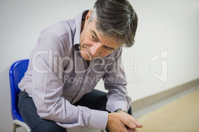 Thoughtful professor sitting on chair