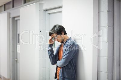 Worried student leaning on wall