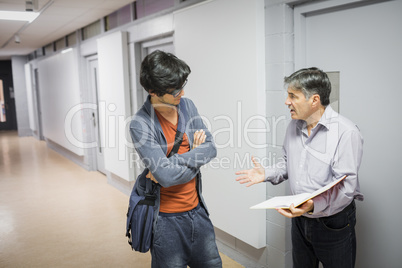 Professor with notebook talking to student