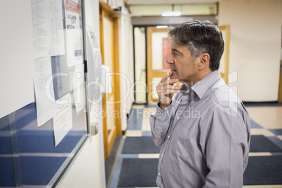 Professor reading notice board