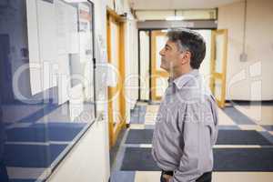 Professor reading notice board