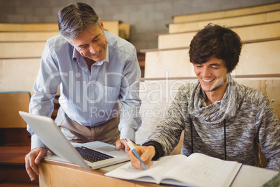 Professor helping a student in classroom