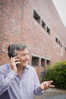 Happy professor talking on phone