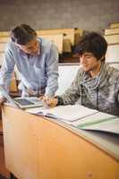 Professor helping a student in classroom