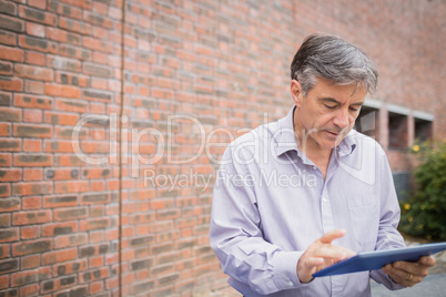 Professor using digital tablet in campus