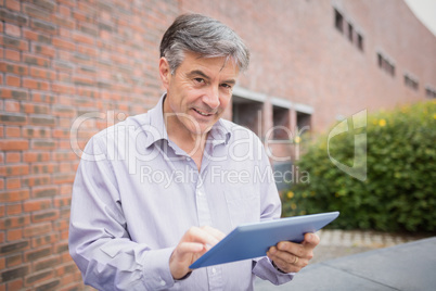 Professor using digital tablet in campus