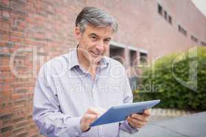 Professor using digital tablet in campus