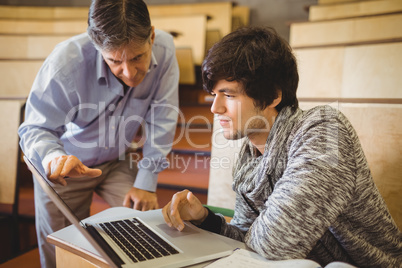 Professor helping a student in classroom