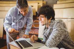 Professor helping a student in classroom