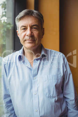 Portrait of professor standing near window