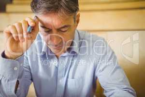 Professor with pen at desk