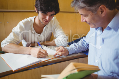 Professor assisting a student with his study