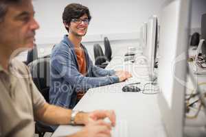 Portrait of happy student using computer