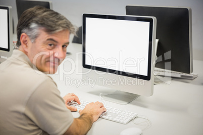 Portrait of happy professor working on computer