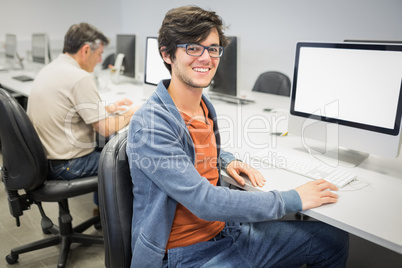 Portrait of happy student using computer