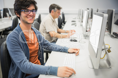 Portrait of happy student using computer