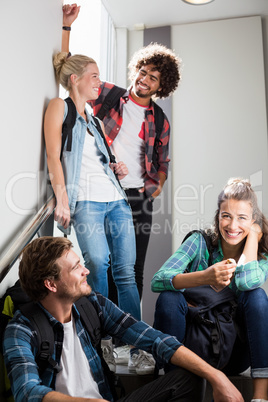 Friends interacting on staircase Friends interacting on staircase