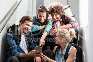 Man showing mobile phone to his friends