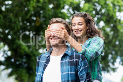 Woman covering her mans eyes