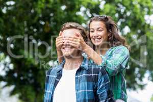 Woman covering her mans eyes