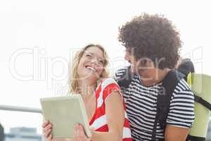 Happy young couple using digital tablet