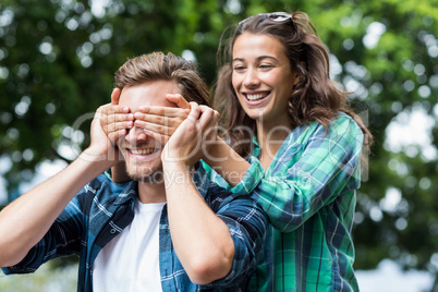 Woman covering her mans eyes