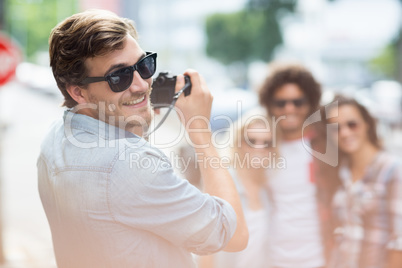 Man taking photo of his friends